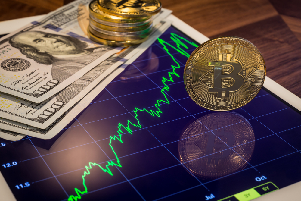 cryptocurrencyandus100dollarbanknotesfocusgoldbitcoinreflect